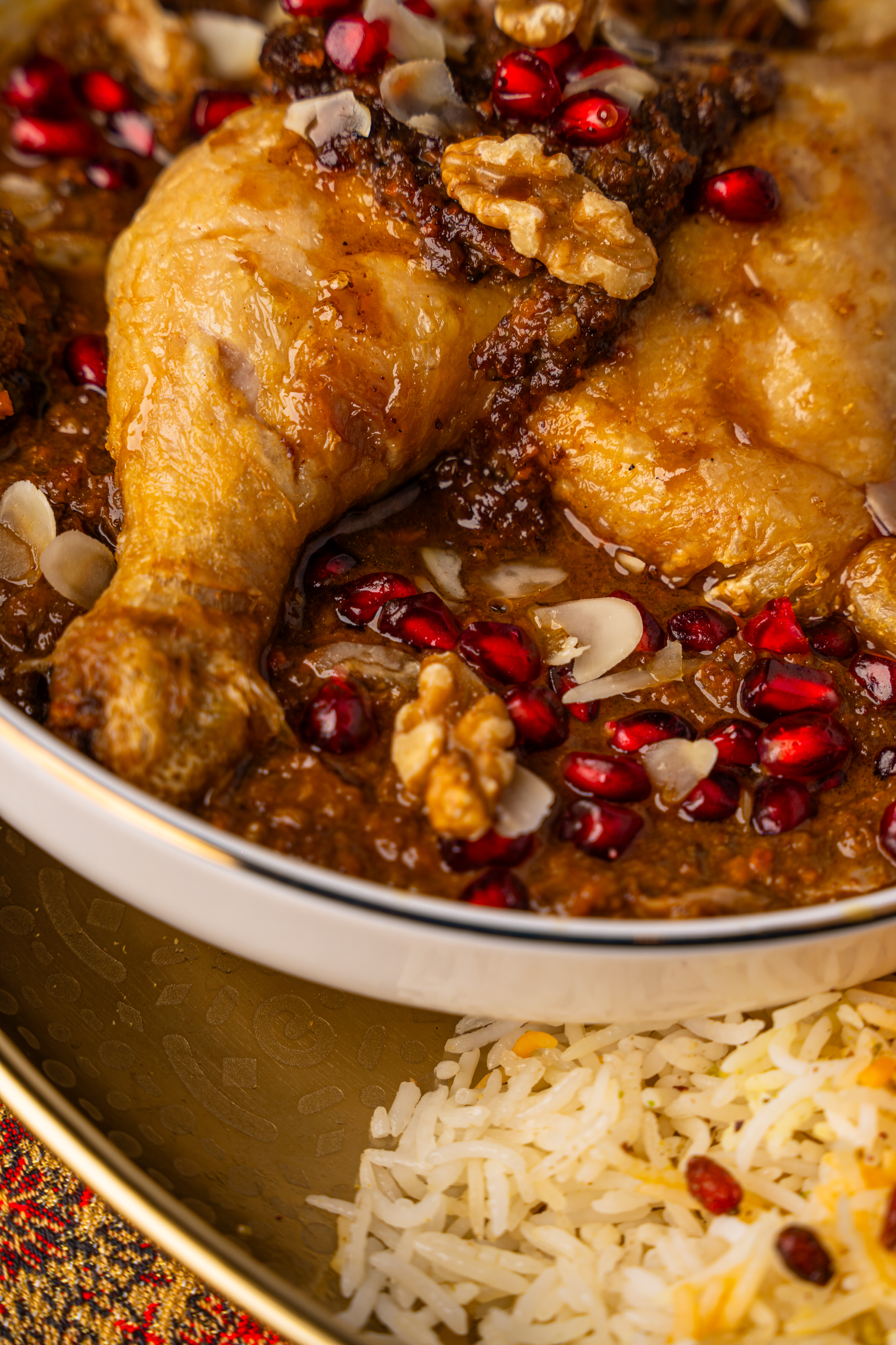 Persian chicken dish with pomegranate and walnuts served with saffron rice